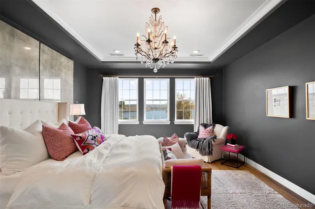 a bedroom with a bed and a chandelier