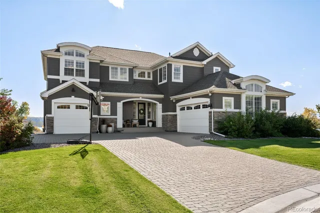 a front view of a house with a yard table and chairs
