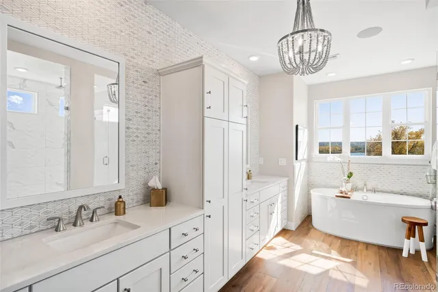 a spacious bathroom with sinks mirror and a bathtub