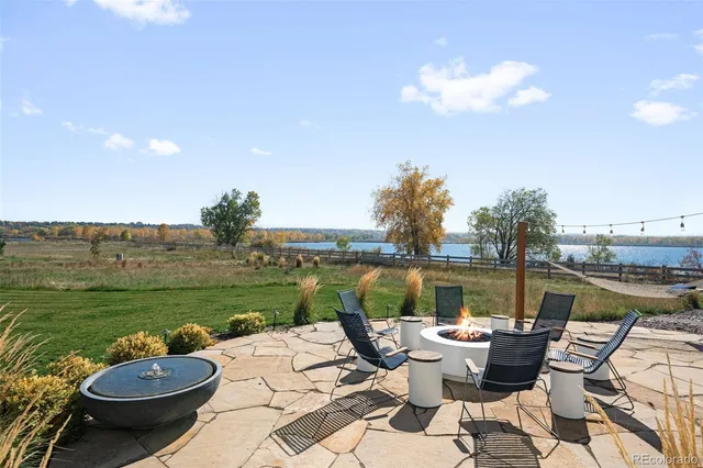 a view of a lake with couches and city view