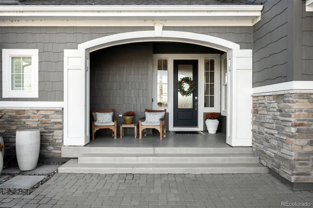 a view of a livingroom with furniture and floor to ceiling window