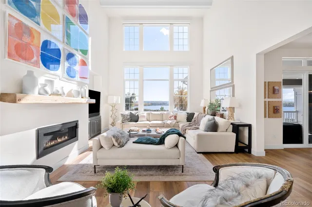 a living room with fireplace furniture and a floor to ceiling window