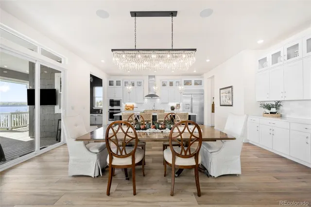 a view of a dining room with furniture and chandelier