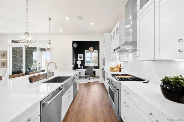 a kitchen with stove a sink and cabinets