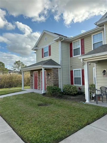 a front view of a house with a yard and porch
