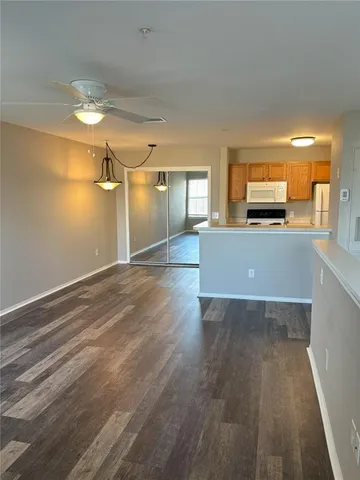 a view of a room with wooden floor and windows