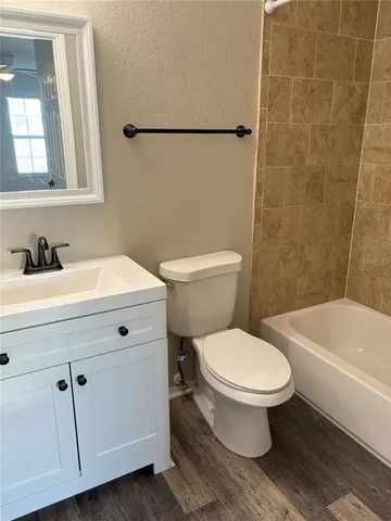 a bathroom with a sink a toilet and bathtub