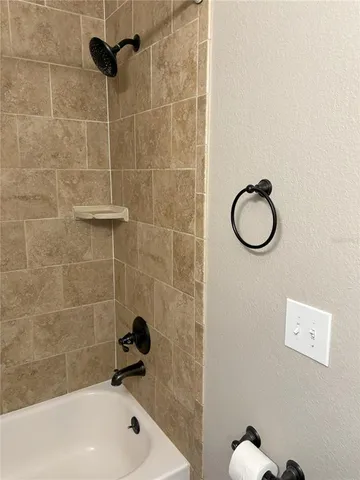 a bathroom with a shower and a bathtub
