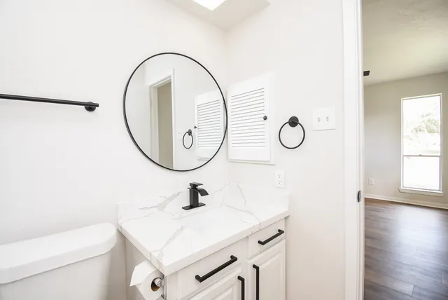 a bathroom with a sink and a mirror