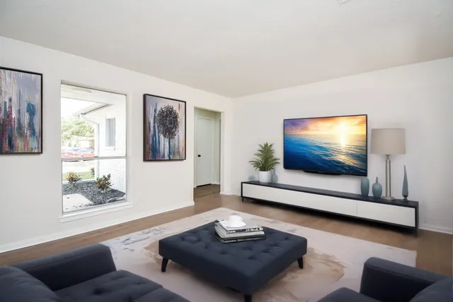 a living room with furniture and a flat screen tv