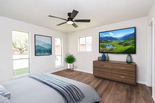 a bedroom with a bed and a flat screen tv