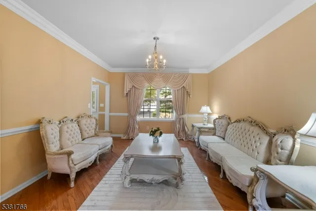 a spacious bedroom with furniture and a chandelier