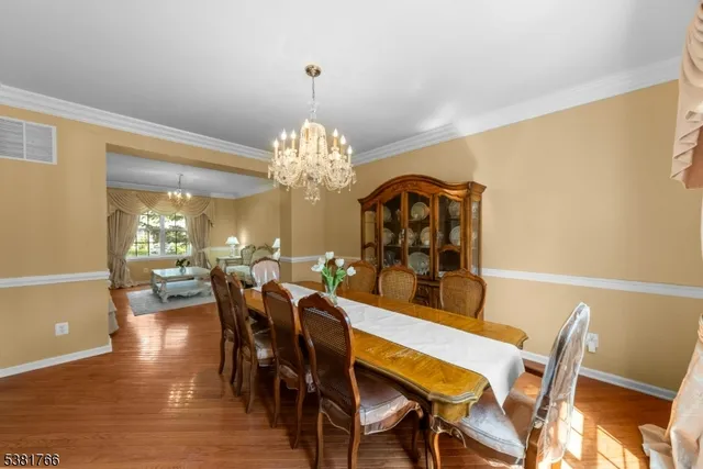 a view of a dining room with furniture and chandelier