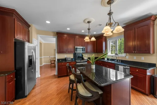 a kitchen with granite countertop lots of counter space dining table and stainless steel appliances