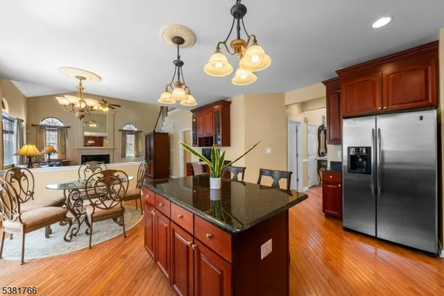 a kitchen with stainless steel appliances granite countertop a stove and a refrigerator