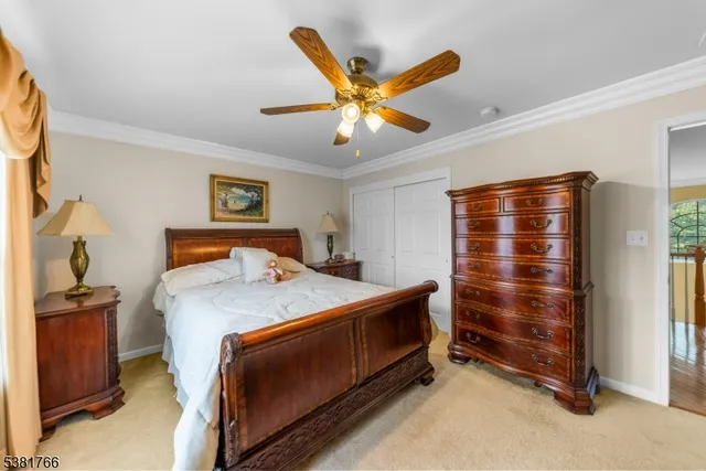 a bedroom with a bed and a ceiling fan