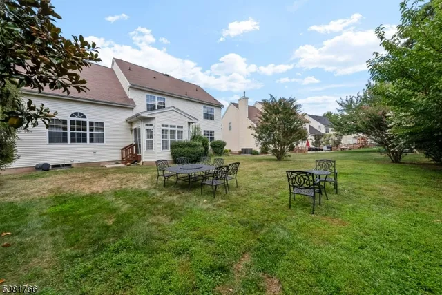 a backyard of a house with table and chairs