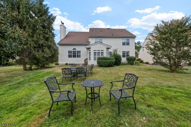 a view of a house with a yard and sitting area