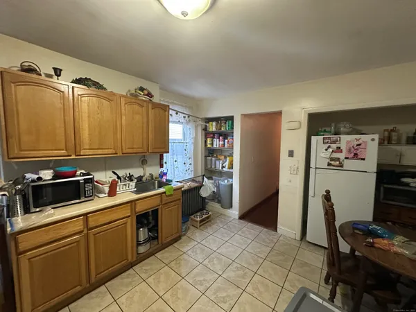 a kitchen with a sink cabinets and appliances