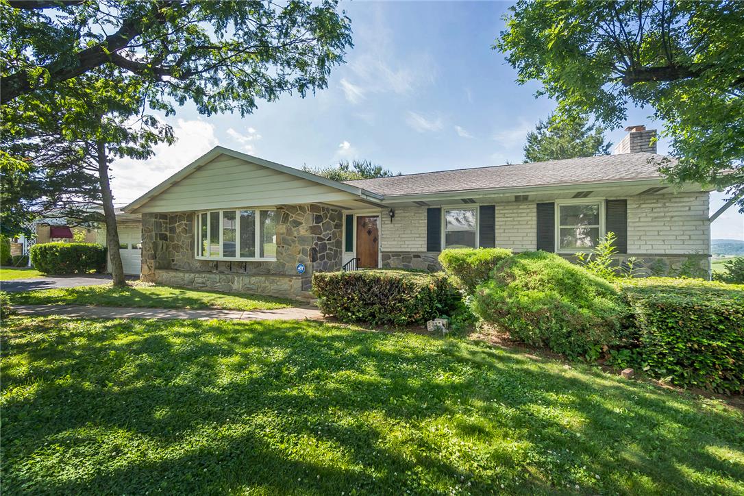 1657 Clearview Road Coplay, PA 18037 - Photo 25 of 77 A classic ranch home features stone and brick siding with a mature, well-kept lawn and vibrant landscaping.
