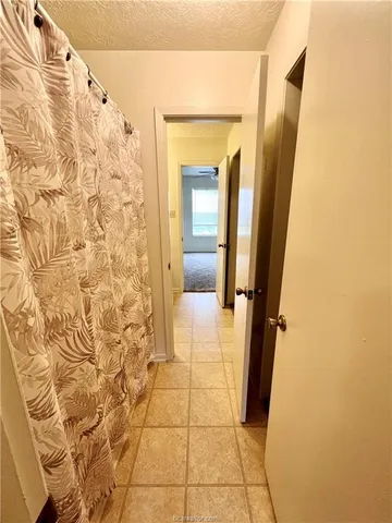 a bathroom with a shower and a mirror