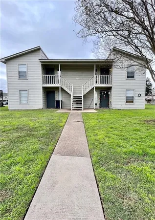 a view of house with backyard
