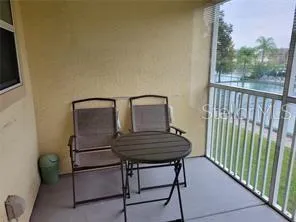a view of balcony with wooden floor and furniture