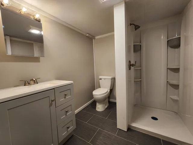 a bathroom with a toilet sink and shower