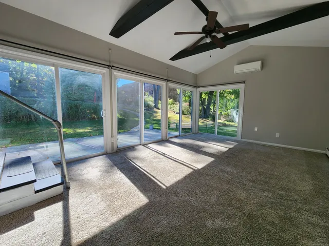 a view of an empty room with windows