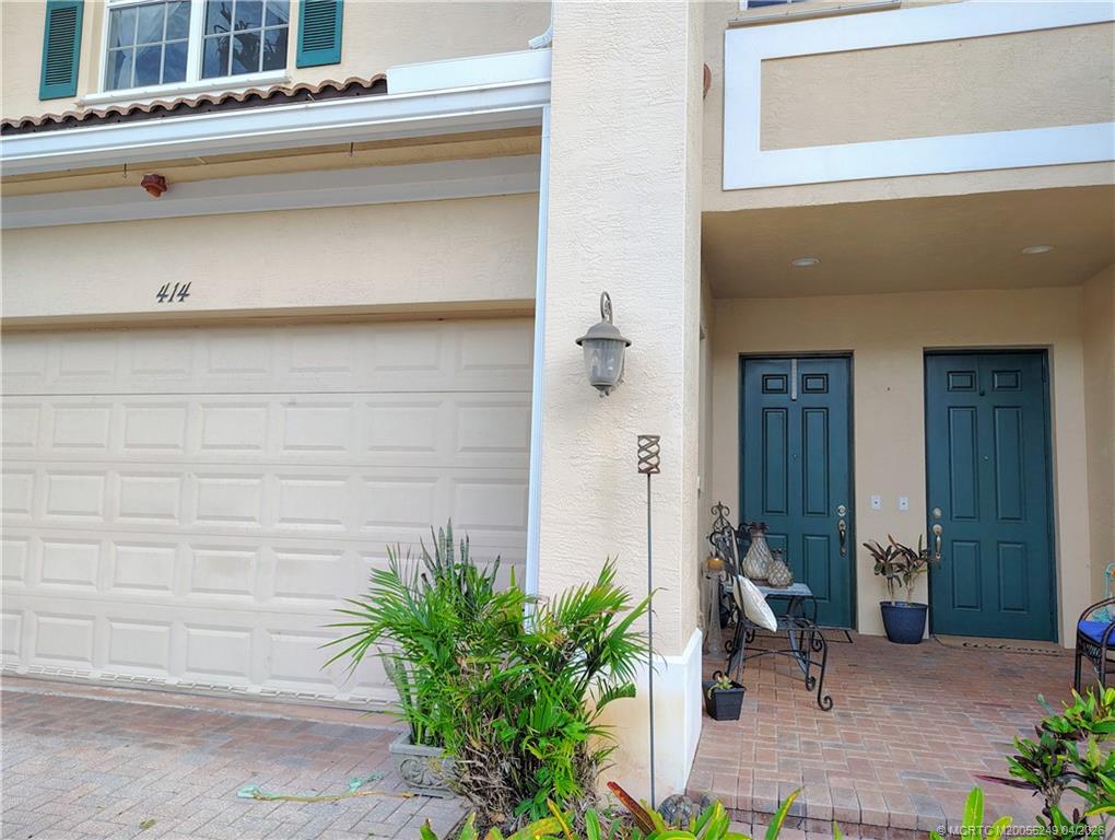 414 Southwest Walking Path, Unit 414 Stuart, FL 34997 - Photo 2 of 15 a bench in front of door