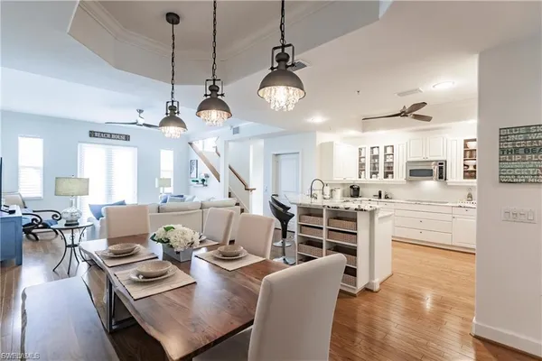 a living room with kitchen island furniture and a chandelier