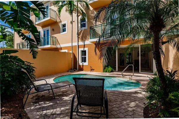 a view of backyard with outdoor seating and plants