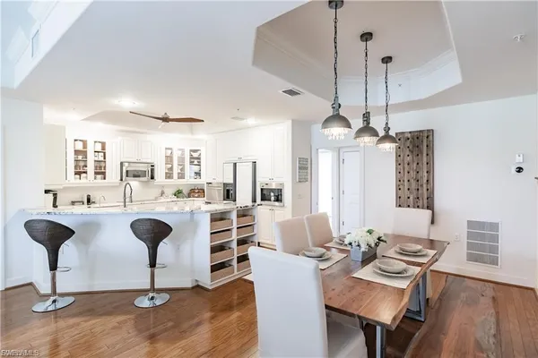a living room with furniture a chandelier and a table