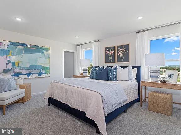 406 Freeman Street Ranson, WV 25438 - Photo 4 of 6 a spacious bedroom with a bed and a couch