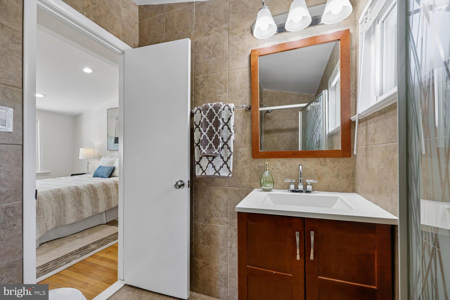 300 Gilsan Court Silver Spring, MD 20902 - Photo 69 of 117 a en suite bathroom with a sink and mirror