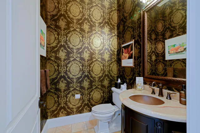 a bedroom with a bed a couch and a flat screen tv