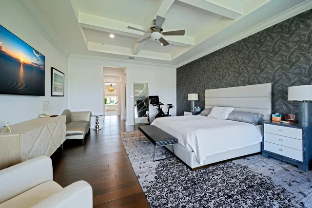 a view of a patio with table and chairs potted plants with floor to ceiling window and potted plants