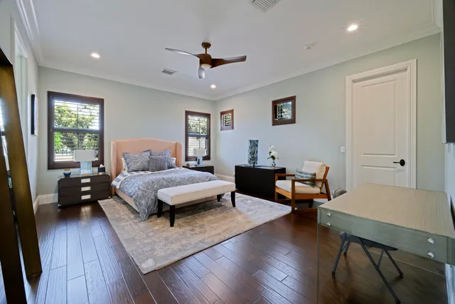a bedroom with a bed table and a window