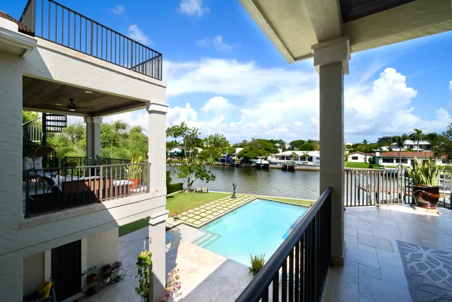 a view of a lake with couches chairs and wooden floor