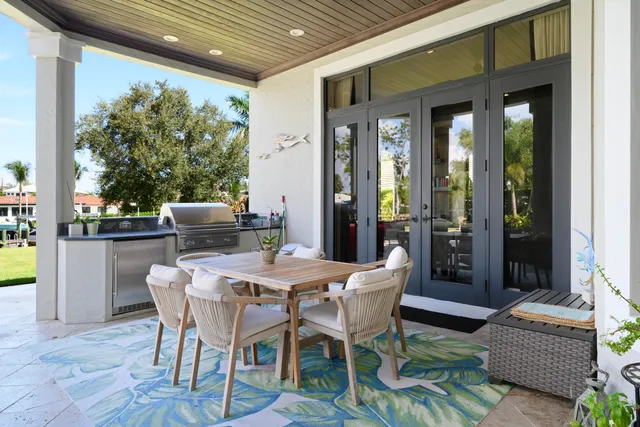 a front view of a house with garden and trees