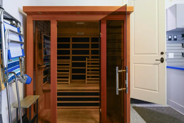a living room with lots of furniture and view of kitchen
