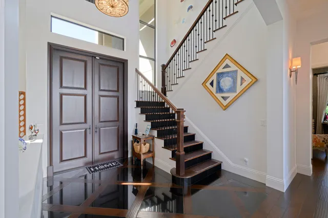 a view of entryway and hall with wooden floor