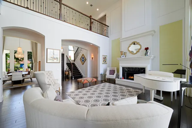 a living room with furniture a fireplace and a large mirror