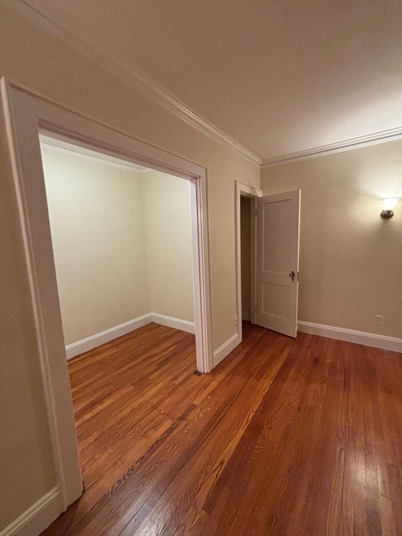 50 Broadway, Unit 27 Beverly, MA 01915 - Photo 6 of 10 a view of an empty room with wooden floor and a window