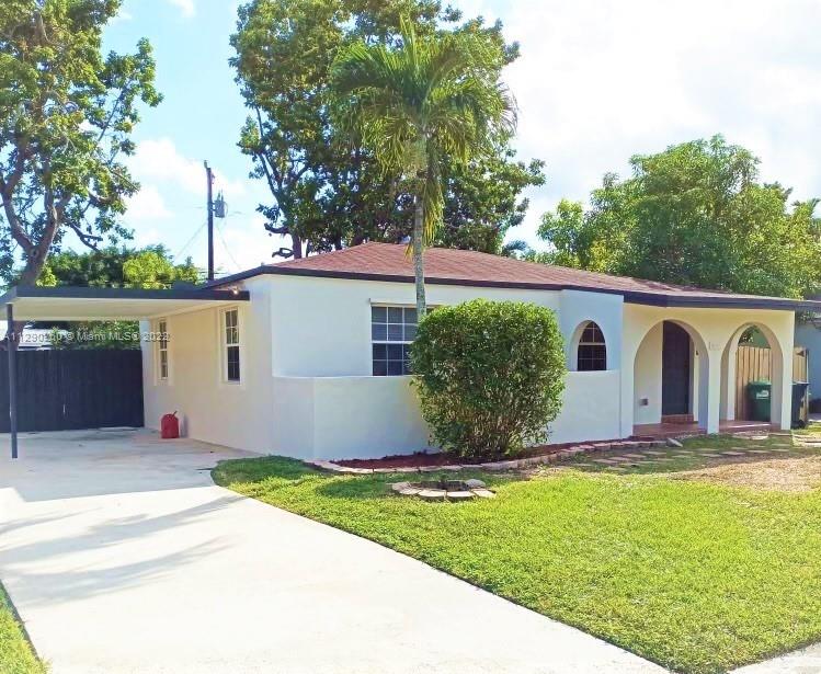 6442 Southwest 37th Street Miami, FL 33155 - Photo 1 of 14 a view of a white house with a yard and large tree
