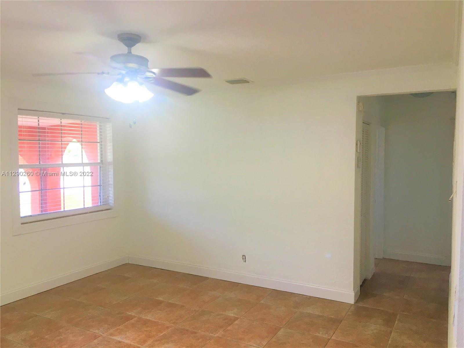 6442 Southwest 37th Street Miami, FL 33155 - Photo 6 of 14 an empty room with a window