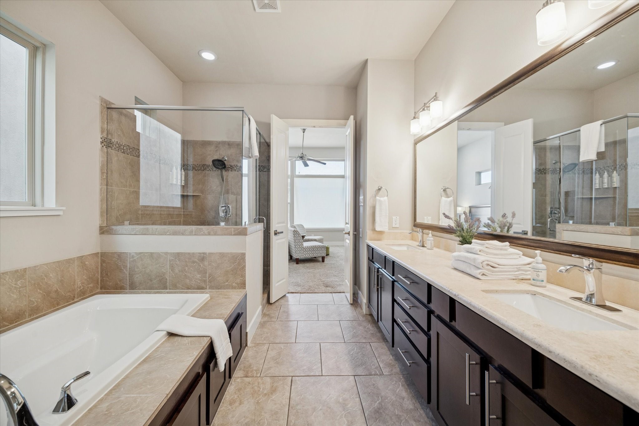 4417 Eli Street Houston, TX 77007 - Photo 12 of 24 Glass-enclosed shower, a soaking tub, and a dual-sink vanity with ample storage. Neutral tones and modern fixtures create a relaxing atmosphere.