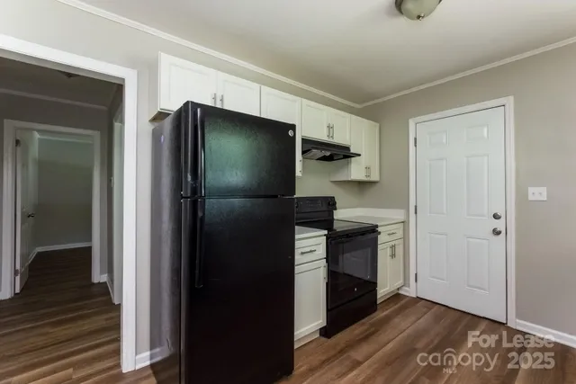 a kitchen with a refrigerator and a sink