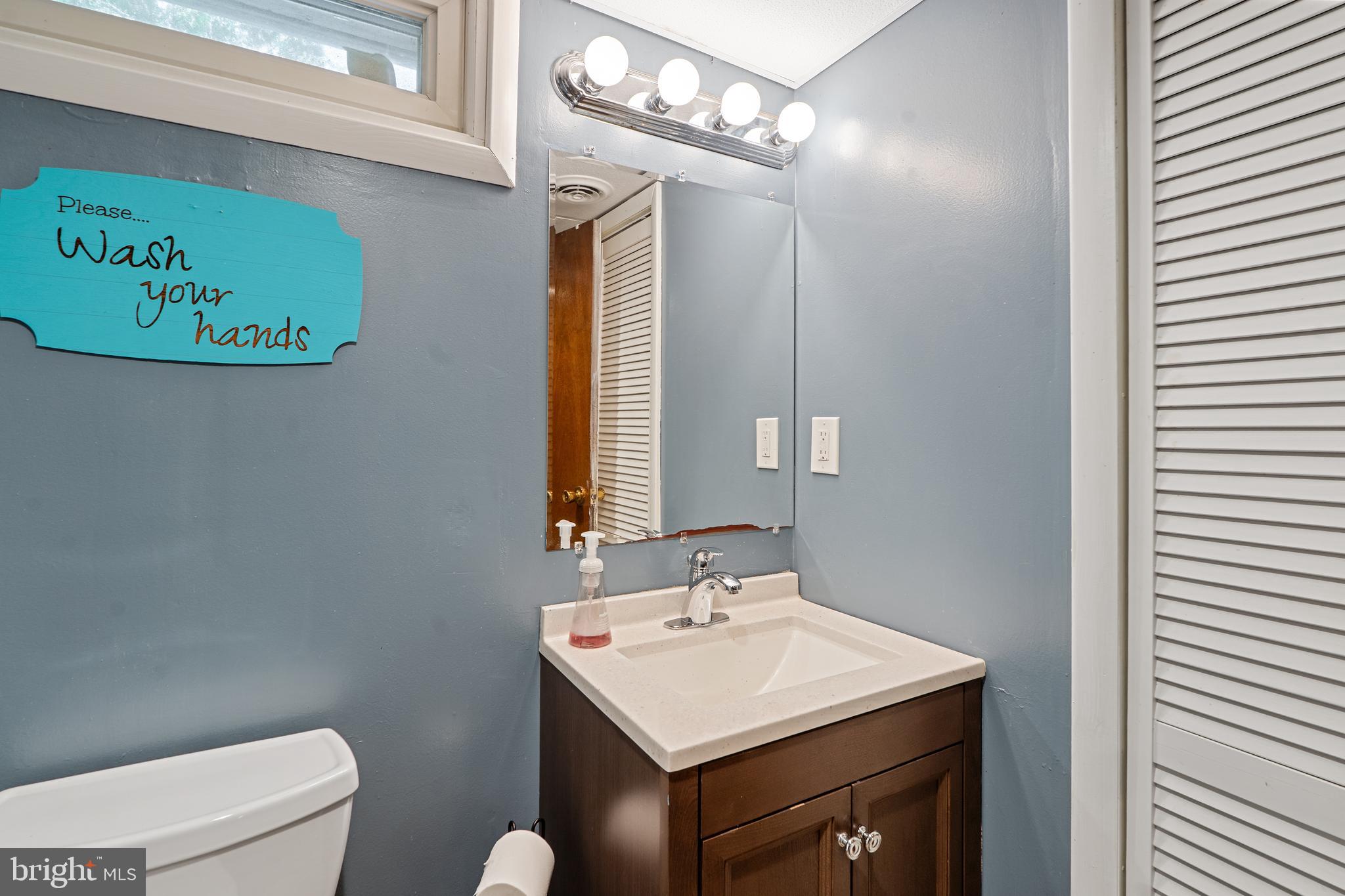 602 Rancocas Avenue Riverside, NJ 08075 - Photo 25 of 40 a bathroom with a sink a toilet and a mirror