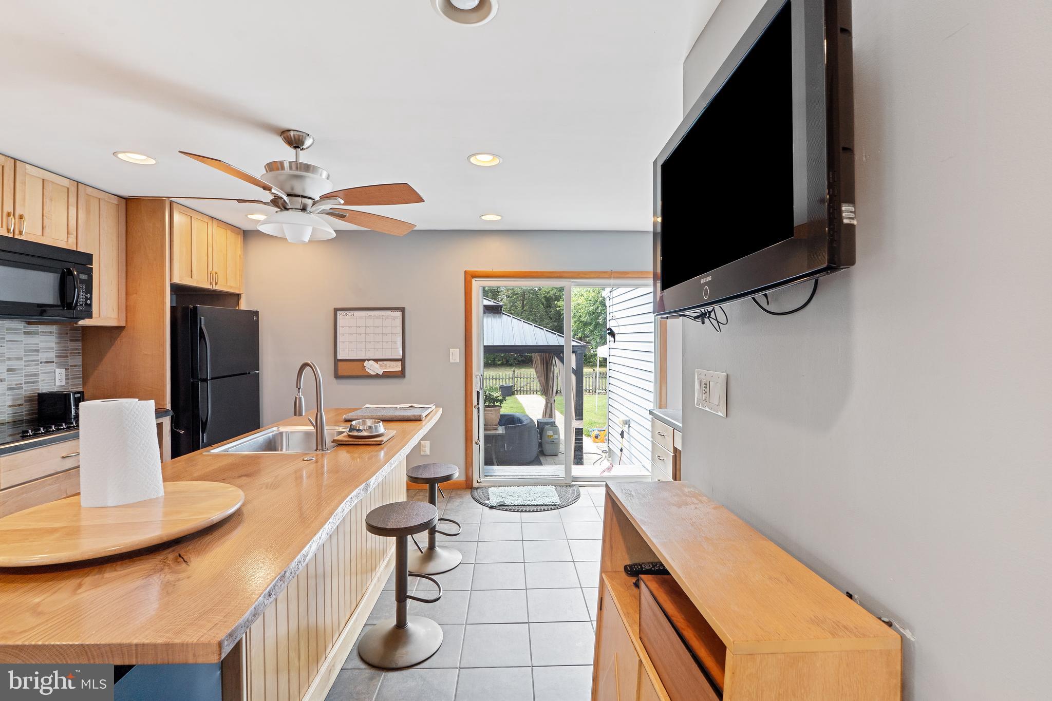 602 Rancocas Avenue Riverside, NJ 08075 - Photo 9 of 40 a dining room with furniture a window and a flat screen tv